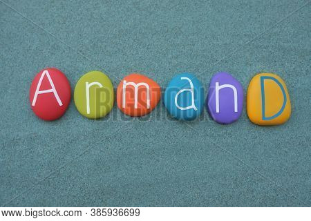 Armand, Masculine Given Name Composed With Multicolored Stone Letters Over Green Sand