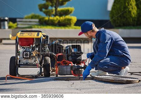Plumber Prepares To Fix The Problem In The Sewer. Repair Work On Troubleshooting.