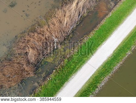 Aerial view of dirt road through marsh lands