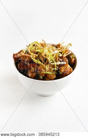 Spicy Garlic Fried Chicken (kkanpunggi). Asian Chicken In Sweet And Sour Sauce In Bowl Over White Ba
