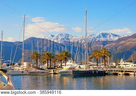 Beautiful Winter Mediterranean Landscape. Yacht  Marina At Foot Of Snow-capped Mountains. Montenegro