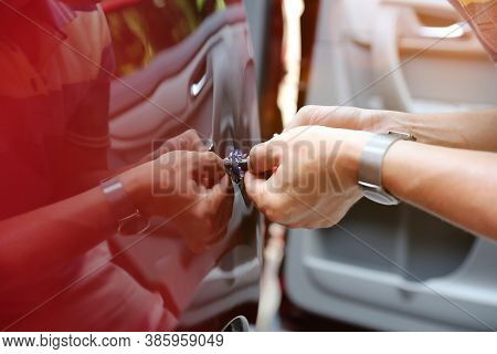Man Fixing Car Dent By Himself. Bodyshop
