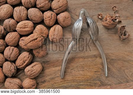 Walnuts And Nutcracker. View From Above.nutcracker And Nuts.walnuts Close-up On Wooden Background. T