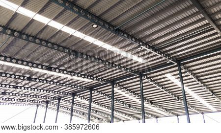 Roof Steel Beam Structure In Industrial Factory, Background Of Factory Ceiling With One Light Blub, 