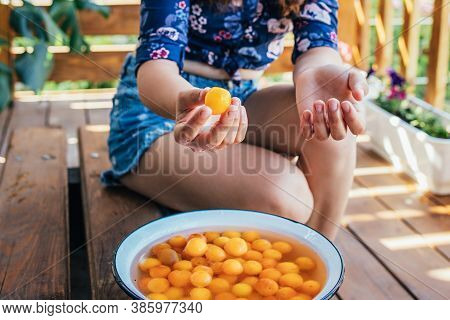 Young Girl Holding Yellow Fruits In Her Hands, Healthy Breakfast, Snack. Selective Focus