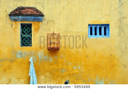Bird Cage on Yellow Wall