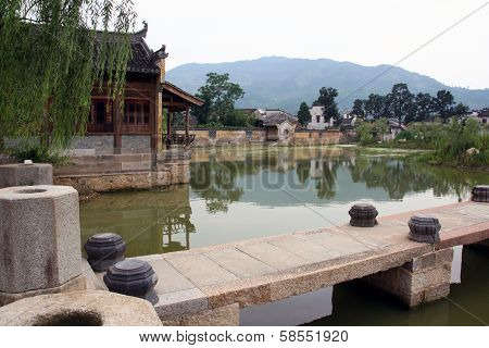 A Stone Bridge Leading To An Ancient Village In Anhui Province, China