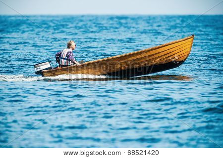 Man With A Fast Vintage Wooden Speedboat