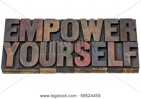 empower yourself - motivation concept - isolated text in vintage letterpress wood type blocks stained vy ink
