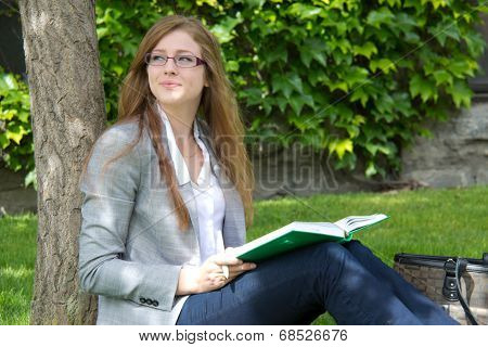 Female College Student Studies Outside On Campus
