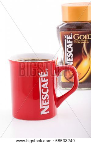 Ankara, Turkey - May 31, 2012: Promotional red Nescafe cup in front of Nescafe Gold instant coffee isolated on white background.