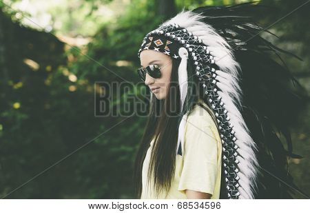 woman in a headdress on the nature background