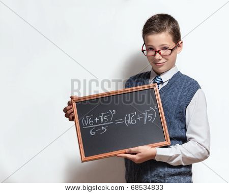 Schoolboy in glasses with mathematical equation