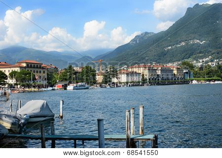 LUGANO, SWITZERLAND - JULY 5, 2014: Lugano city and shoreline.The affluent city in southern Switzerland sits on the shores of Lake Lugano a popular tourist destination.