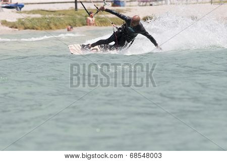 Professional  Kitesurfer Jumps Over The Water During Training On Lake Of Santa Croce