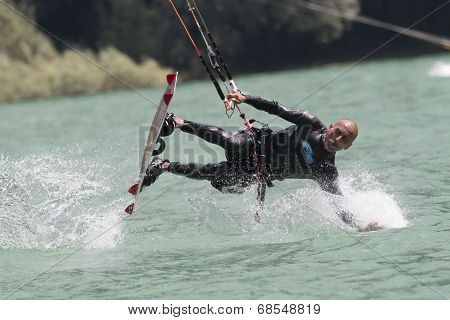 Professional  Kitesurfer Jumps Over The Water During Training On Lake Of Santa Croce