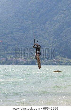 Professional  Kitesurfer Jumps Over The Water During Training On Lake Of Santa Croce
