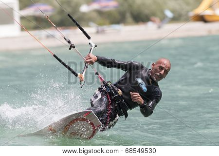 Professional  Kitesurfer Jumps Over The Water During Training On Lake Of Santa Croce