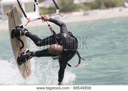 Professional  Kitesurfer Jumps Over The Water During Training On Lake Of Santa Croce