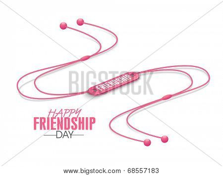 Happy Friendship Day celebrations concept with pink wrist band on white background. 