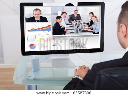 Businessman Video Conferencing With Team