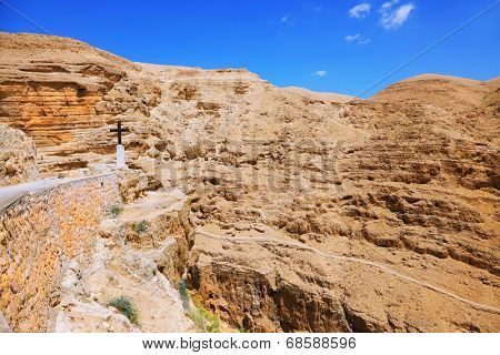 Monastery of St. George the Victorious.  The road leading to the temple. The building of the monastery was built on the wall of the gorge of Wadi Kelt near Jerusalem