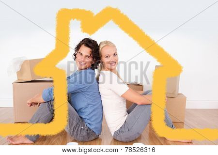 Couple sitting on the floor against house outline
