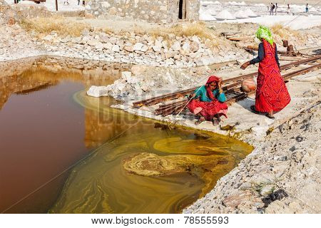 SAMBHAR, INDIA - NOVEMBER 19, 2012: Women mining salt at lake Sambhar, Rajasthan, India. Sambhar Salt Lake is India's largest inland salt lake
