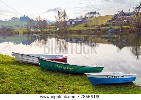 ZAWOZ, POLAND, NOVEMBER 09, 2014: Fishing boats moore on shore of Solina Lake in Bieszczady