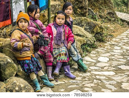 Gang Of Four Young Girls Wait Along The Road.