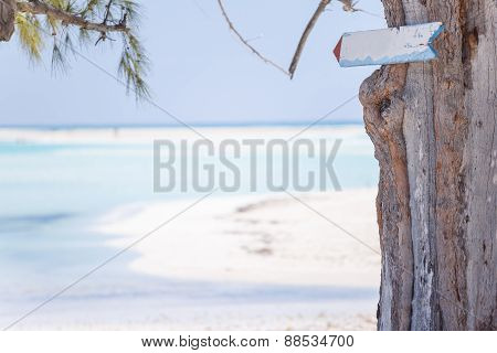 Sign on the paradisaic beach