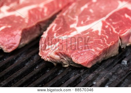 Fresh beef steaks on grill or BBQ