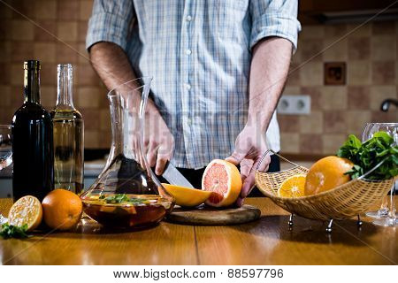Man cuts fresh grapefruits