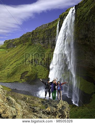 Group Of Climbers On The Waterfall Background