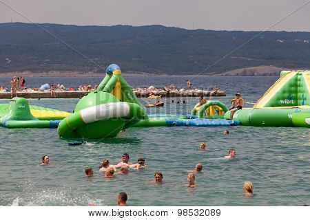 SELCE, CROATIA - JULY 24, 2015: People swimming and sunbathing on the Selce beach