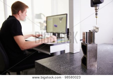 Male Engineer Using CAD System To Work On Component
