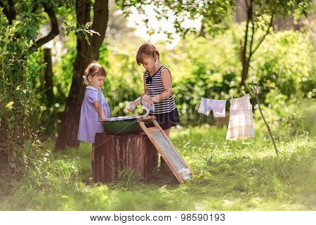 Little Helper Girls Sisters Washes Clothes Using The Washboard Outdoors