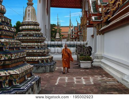 BANGKOK - THAILAND - AUGUST 2008: Tibetan monk walks between the pillars of the temple. Entrance with monk of Tibetan Buddhism Temple
