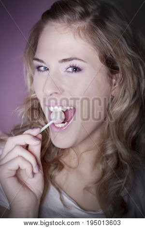 Portrait of a young woman with lollipop