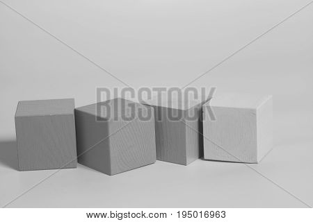 Wooden cubes on a gray background .