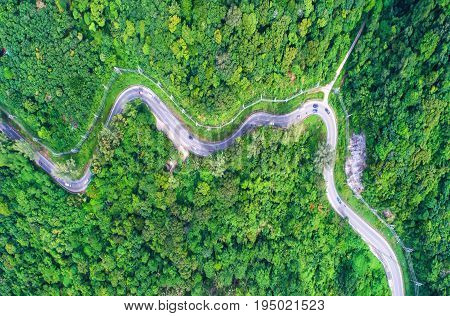 aerial viewTop viewamazing nature background.Winding road on the mountain.And the car ran.A beautiful view.thailand