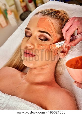 Collagen face mask. Facial skin treatment. Face of woman receiving cosmetic procedure in beauty salon close up . Paraffin mask for skin.