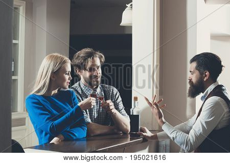 Woman And Man Toasting Glasses Of Wine At Bar