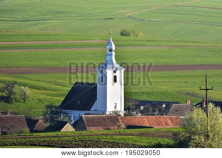 View of white church in a village. Aita Seaca Covasna. Romania