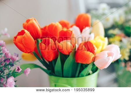 Artificial decArtificial decorative pink red and yellow tulips in a vaseorative pink tulips