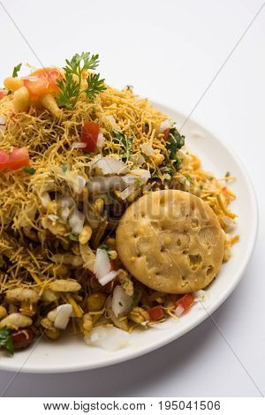 Bhel Puri - Popular Mumbai street food served with coriander and tamarind chutney on white background, selective focus