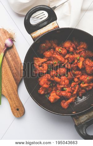 Gobi Manchurian dry - Popular street food of India made of cauliflower florets in a frying pan, selective focus