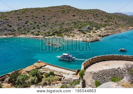 Top Of Spinalonga Island. View To Blue Aegian Sea With Boats And Kalydon Island.