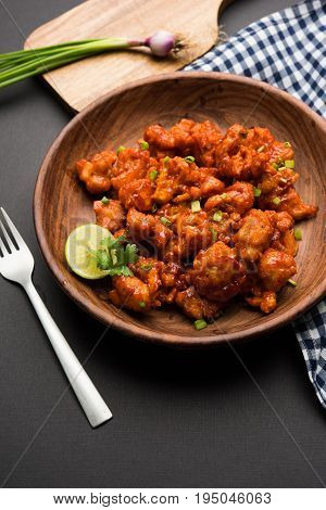 Gobi Manchurian dry - Popular street food of India made of cauliflower florets, selective focus