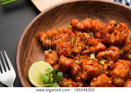 Gobi Manchurian dry - Popular street food of India made of cauliflower florets, selective focus